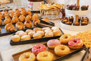 a display of different types of donuts and other pastries at Hotel Marco Polo in Lido di Jesolo