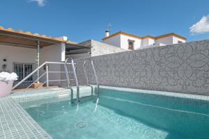 a swimming pool in front of a house at Casa Rocio in Hozanejos