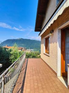 a walkway next to a building with a mountain in the background at Iseo Lake Terrace in Sale Marasino