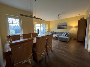 a living room with a table and chairs and a couch at Gemütliche strandnahe Ferienwohnung in Bansin