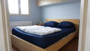 a bed with blue and white sheets and blue pillows at Park Welgelegen, bungalow 28 in Cadzand +9 photos