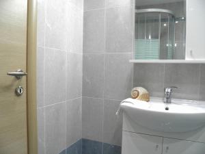 a bathroom with a sink and a mirror at Majestic Blue in Mandrakia +11 photos