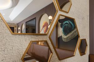 a woman taking a picture of herself in a mirror at Hotel Marco Polo in Lido di Jesolo