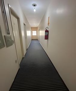 a long hallway with a black and white striped floor at LN Flats & Suites in Uberlândia
