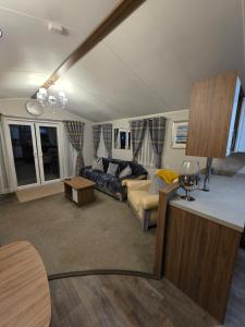 a living room with a couch and a table at Tw Luxury Caravan in Longridge