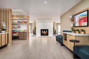 a living room with a fireplace in a building at Sonesta ES Suites Toronto Markham in Markham