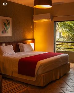 a bedroom with a large bed with a large window at Hotel OT in Três Lagoas +63 photos