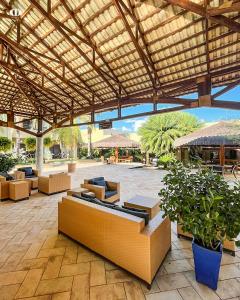 a pavilion with couches and tables in a patio at Hotel OT in Três Lagoas