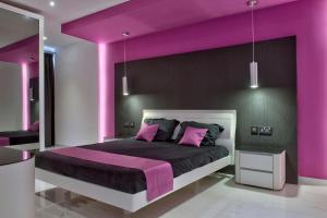 a purple bedroom with a large bed with purple walls at Apartment with Private Jacuzzi and Terrace in St Julians 3 Bedrooms in St. Julianʼs