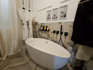 a white bath tub in a bathroom with a shower at Be Your Home - My Attitude in Civitavecchia