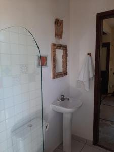 a white bathroom with a sink and a shower at Casa Jeri Duo in Jericoacoara +33 photos