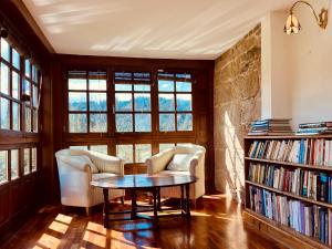 a living room with two chairs and a table at Prioral Countryside Villa in Miño