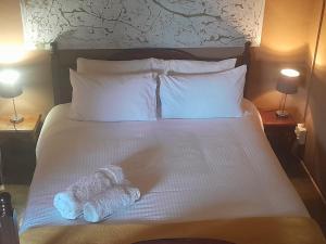 a bed with two stuffed animals sitting on it at African Bushveld 129A 1 x Bachelor Unit in Buffelspoort +124 photos