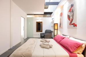a bedroom with a large bed with two teddy bears on it at Industrial Loft - Garage-Netflix-wifi in Brescia