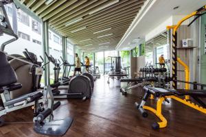 a gym with a bunch of treadmills and machines at Elio Sukhumvit 64 in Bangkok