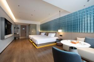 Voodi või voodid majutusasutuse Liangzhi Huipin Hotel Haikou West Coast Yongwan Road Branch toas