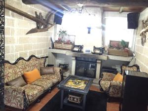 a living room with a couch and a fireplace at Agro da Gandarela in Teo +114 photos