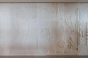 a room with a wall with sculptures on it at Plus Fariones Suite Hotel in Puerto del Carmen