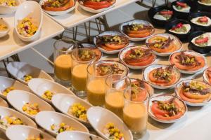 a buffet with plates of food and glasses of orange juice at Plus Fariones Suite Hotel in Puerto del Carmen