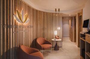a hotel lobby with two chairs and a table at Plus Fariones Suite Hotel in Puerto del Carmen