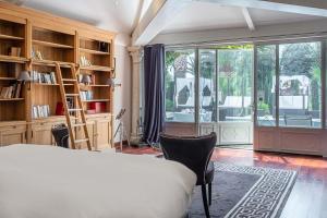 a bedroom with a bed and a book shelf at La Villa Mauresque in Saint-Raphaël