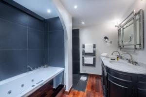a bathroom with two sinks and a large tub at La Villa Mauresque in Saint-Raphaël