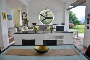a kitchen with a table with a bowl on it at Villa en Club Campestre Mesa de Yeguas in Anapoima +8 photos