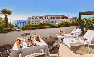 a restaurant with a view of the ocean on a balcony at Hôtel Barrière Le Gray d'Albion in Cannes