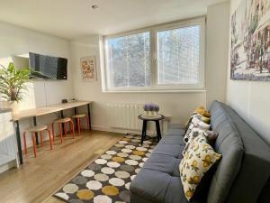 a living room with a couch and a table at Convenient quiet flat with parking in Andover