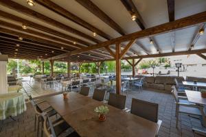 a restaurant with wooden tables and chairs and a patio at Gasthaus Rössli in Gipf-Oberfrick
