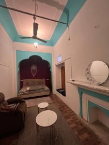 a living room with a bed and a table at Shafar Manzil in Jaipur