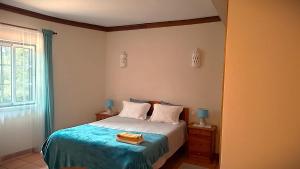 a bedroom with a bed with a blue blanket at Aljezur Coast Apartment - Villa Luar in Aljezur +21 photos