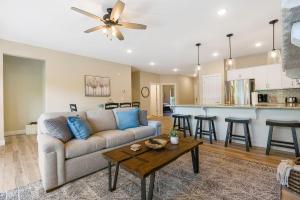 a living room with a couch and a table at Lake Taneycomo Views-Near Branson Landing-Cmty Outdoor Pool-Free Tickets-Elevator! in Branson