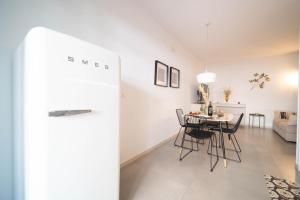 a dining room and living room with a table and chairs at Opuntia Home in Monopoli
