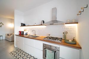 a kitchen with a stove and a counter top at Opuntia Home in Monopoli
