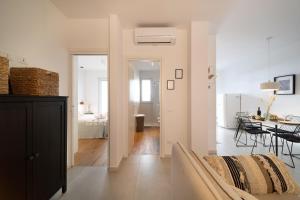 a living room with a bed and a dining room at Opuntia Home in Monopoli