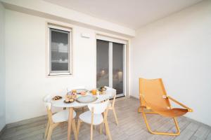a dining room with a table and chairs at Opuntia Home in Monopoli