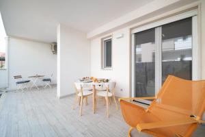 a dining room with a table and chairs at Opuntia Home in Monopoli