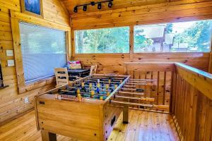 a large wooden room with a foosball table in it at Cozy Cabin Wgame Room, Hot Tub & Creek in Pigeon Forge