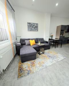 a living room with a couch and a table at Ferienwohnung Glücks-Burg "Sonne" in Glücksburg