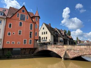 a bridge over a river in a city with buildings at apart N serviced apartments in Nuremberg