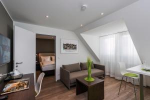 a living room with a couch and a table at apart N serviced apartments in Nuremberg