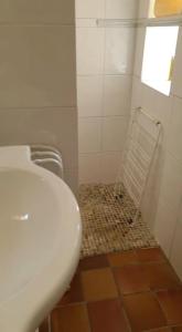 a bathroom with a toilet and a sink and a window at Villa santa karina in Linguizzetta
