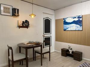 a dining room with a table and chairs and a painting at YongDamJae in Seoul +68 photos