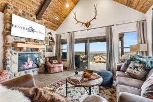 a living room with a couch and a fireplace at New Log Cabin with Ozark Sunset Views, $400 Daily Activities Included, Pickleball in Branson