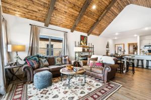 a living room with a couch and a table at New Log Cabin with Ozark Sunset Views, $400 Daily Activities Included, Pickleball in Branson