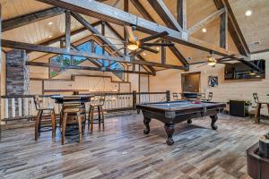 a large room with a pool table and chairs at Pvt Indoor Pool-Basketball Court-Theatre Room & Hot Tub-Games-Sleeps 46-Table Rock View-Free Tickets in Branson