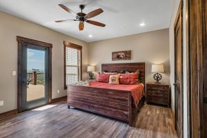 a bedroom with a bed and a ceiling fan at Pvt Indoor Pool-Basketball Court-Theatre Room & Hot Tub-Games-Sleeps 46-Table Rock View-Free Tickets in Branson +100 photos