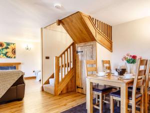 a dining room with a table and chairs and a stairway at 2 Bed in Launceston 81077 in Saint Giles on the Heath