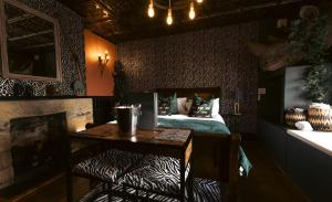 a bedroom with a bed and a table and a desk at St Hildas Complex in Hinderwell